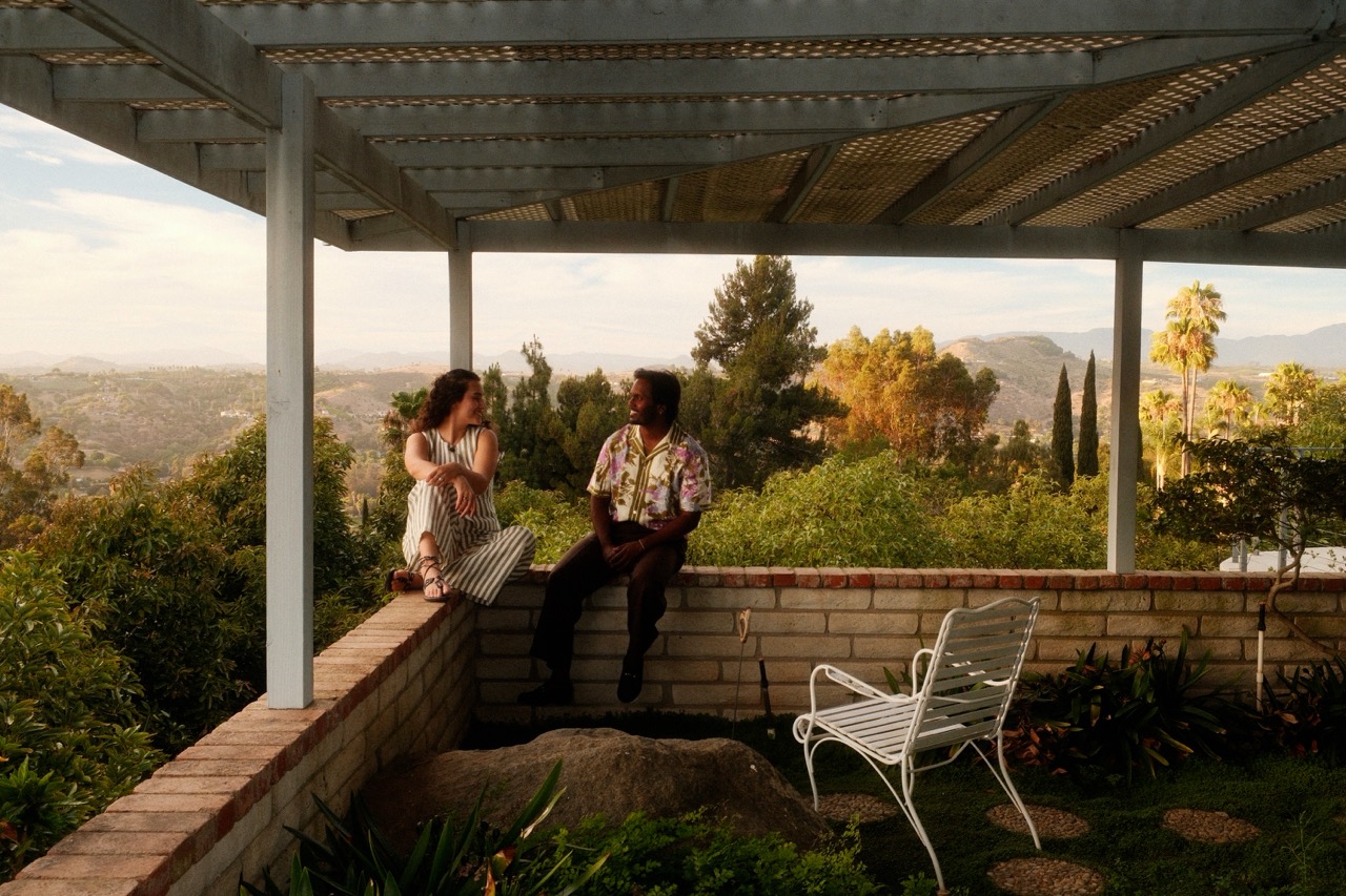 A couple sharing a quiet moment on a hillside terrace
